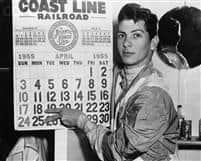 Jockey Bill Hartack has reason to point with pride as he indicates his two big days, April 18 and April 25 at Laurel. Hartack was aboard six winners in seven races at Laurel on the 25th, and on April 18 he rode five consecutive winners plus two seconds in seven races. April 29, 1955.